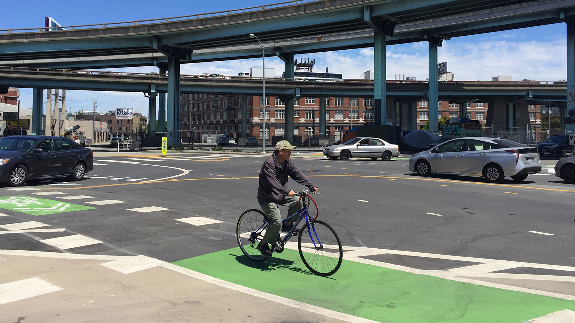 Person on bicycle riding on a bike lane through an intersection