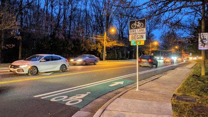 Image of cars driving along Seminary Road at dusk.