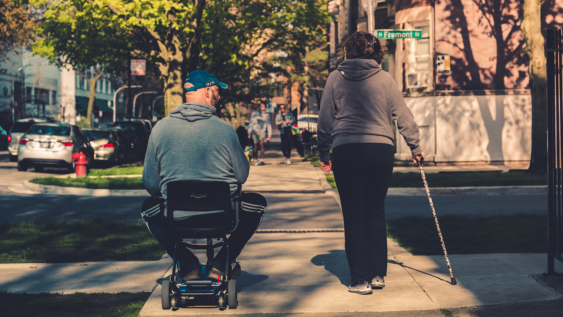 Couple with a wheelchair and cane