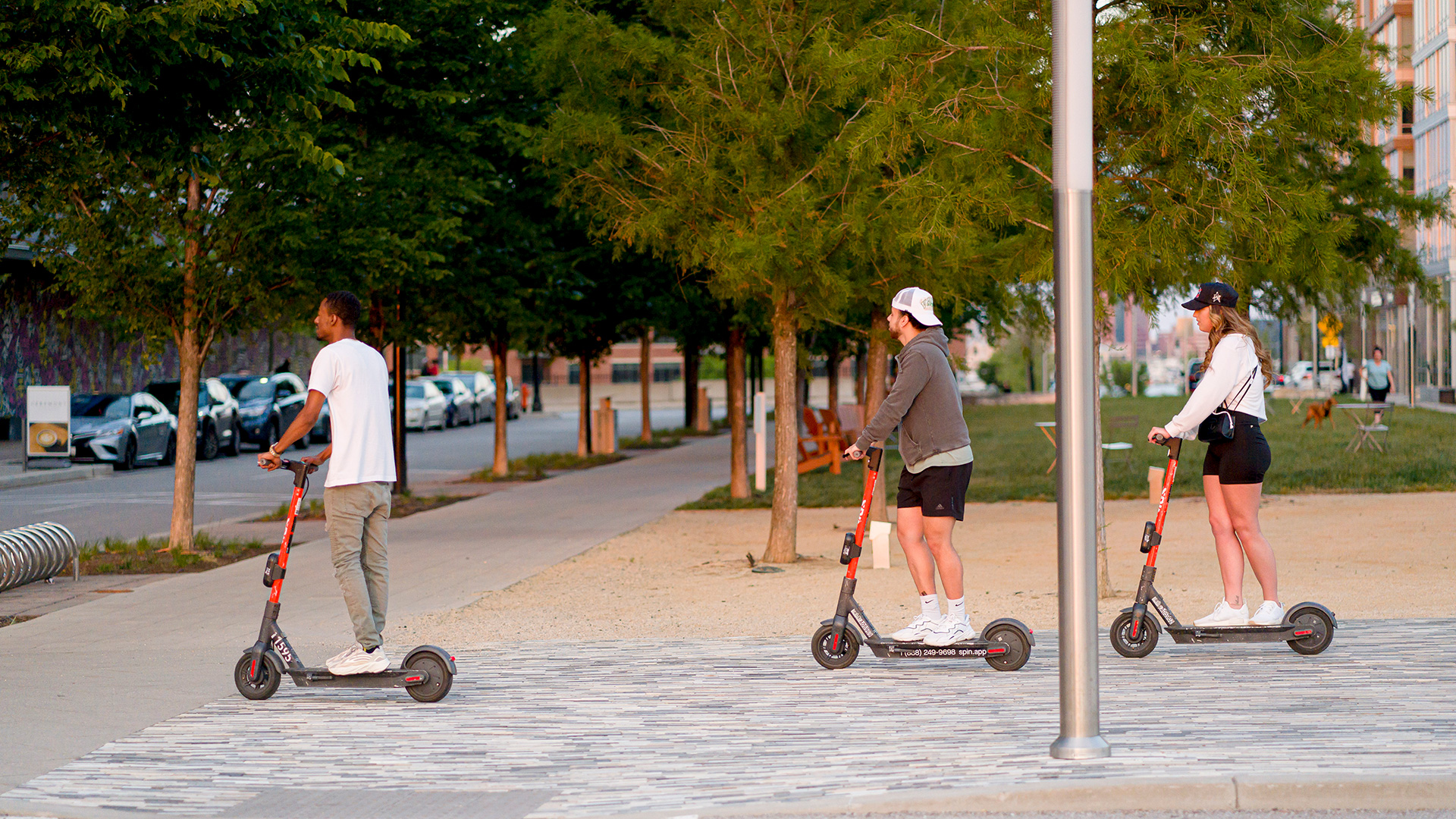 Three People Riding E-Scooters in Baltimore