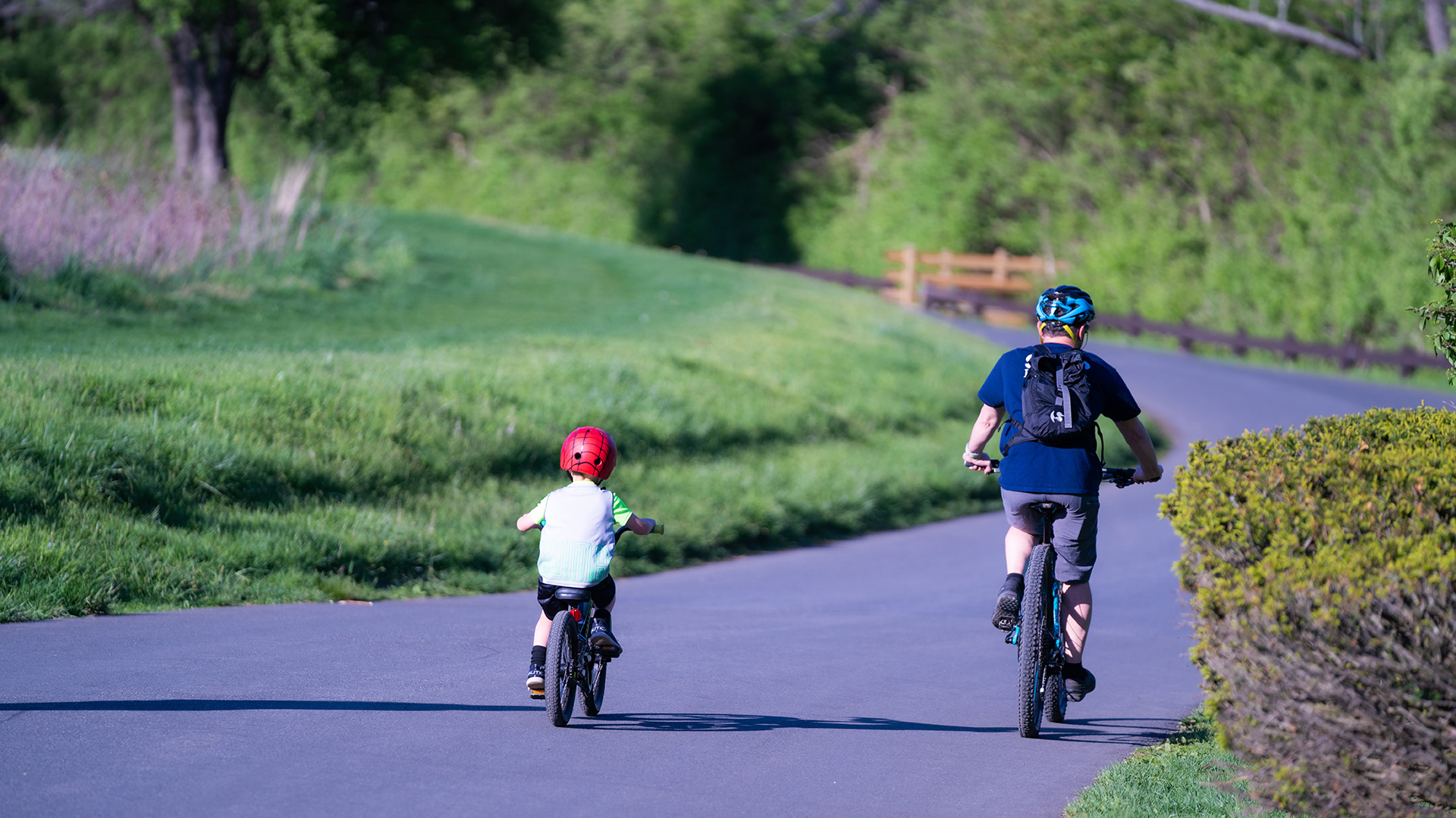 Parent and Child Riding Bikes on Multi-Use Path