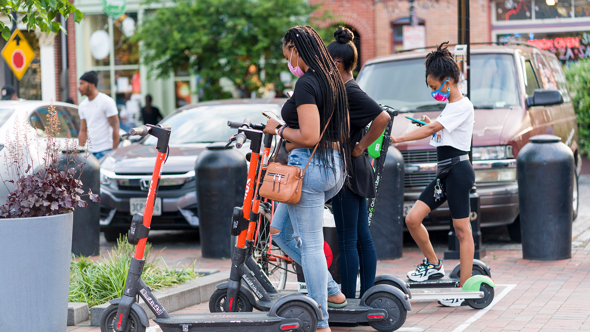 Group of Girls Unlocking E-Scooters