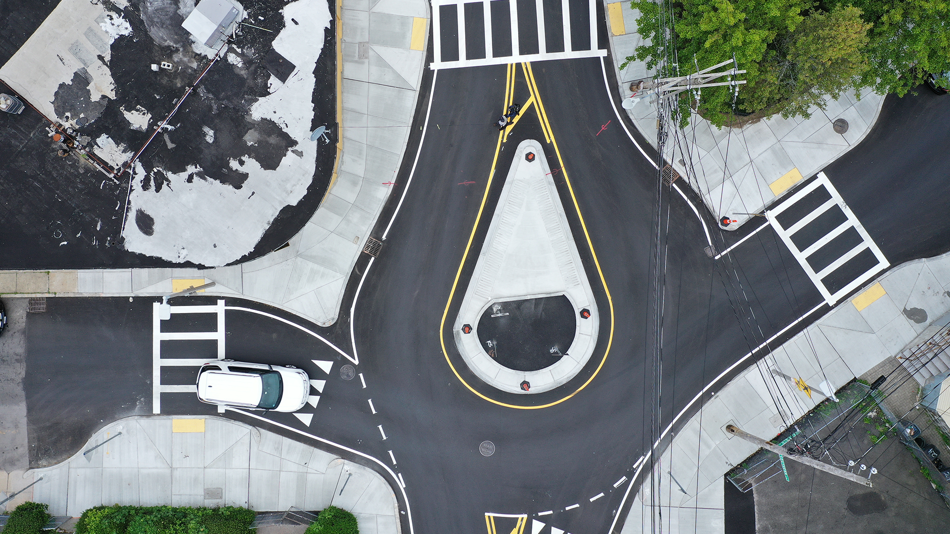 Image of an intersection with a comma shaped roundabout in the center