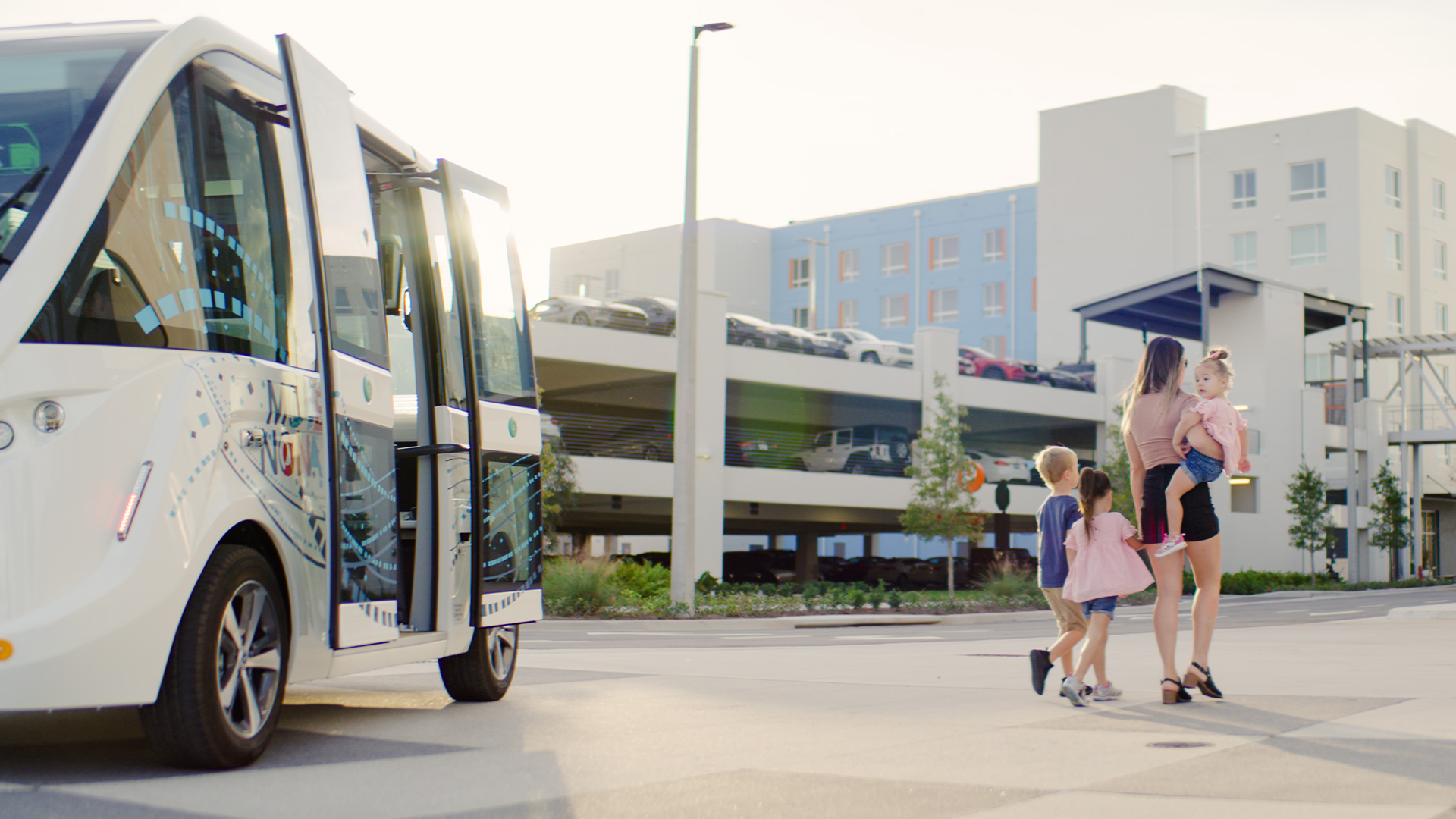 Passengers exit an automated shuttle