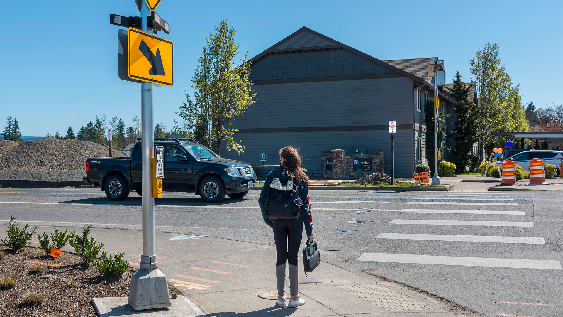 Student crossing street at crosswalk