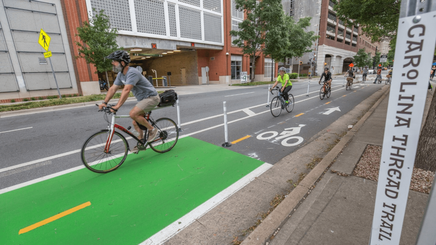 Bicyclists ride down the Charlotte Uptown Cycle Track