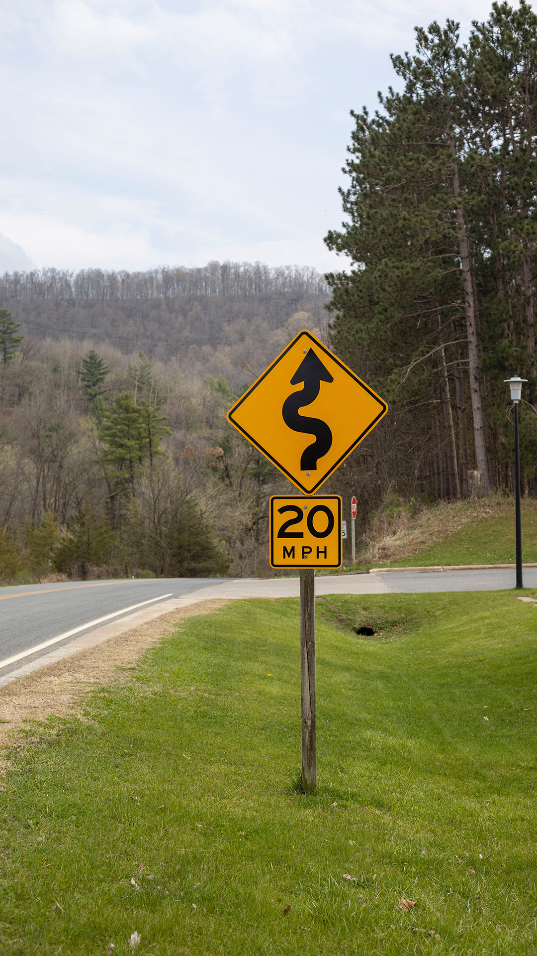 Yellow winding road sign and 20 mph sign