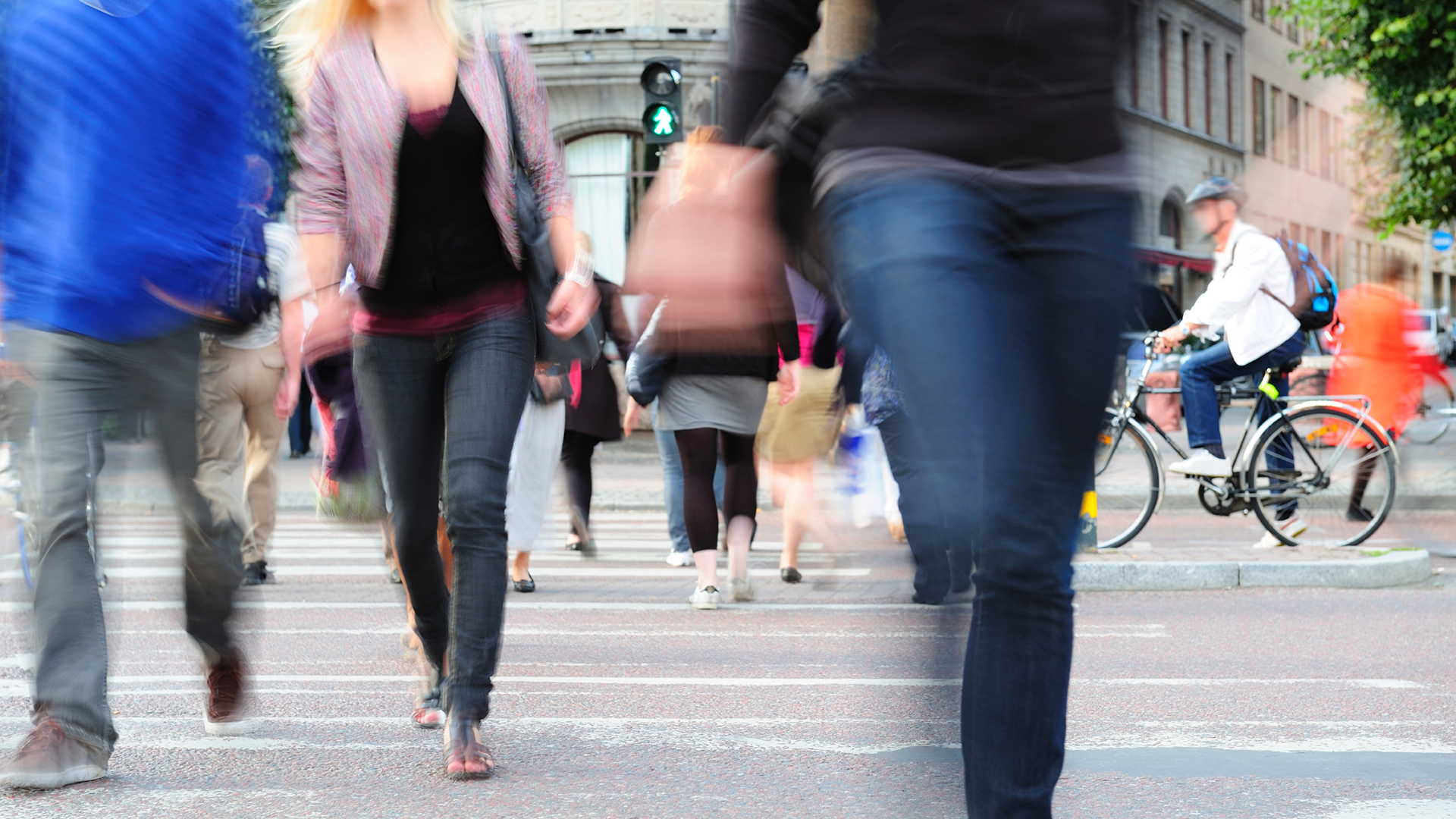 Blurry people walking through crosswalk