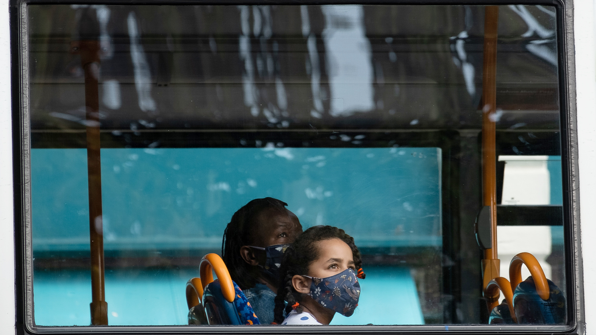 Two people on bus with masks on