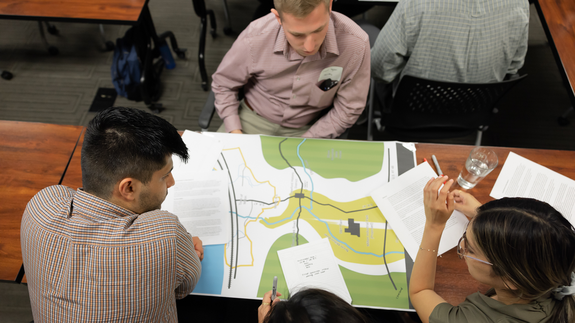 Transportation engineering/planning interns gathered around a map