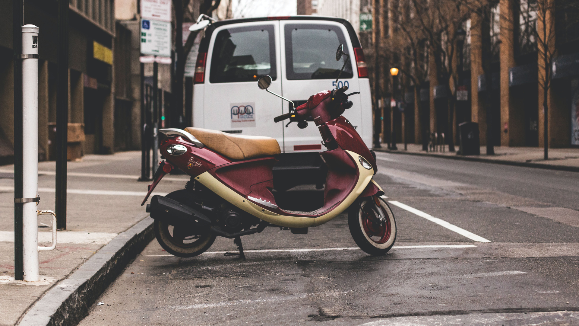 Van and motorcycle parked at the curbside