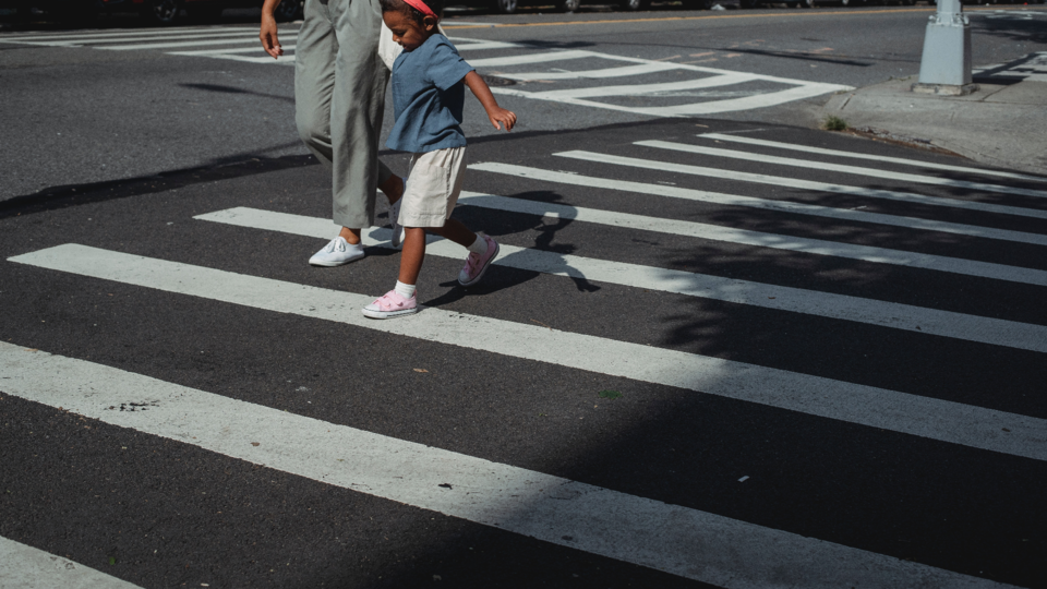 Parent and child crossing the street