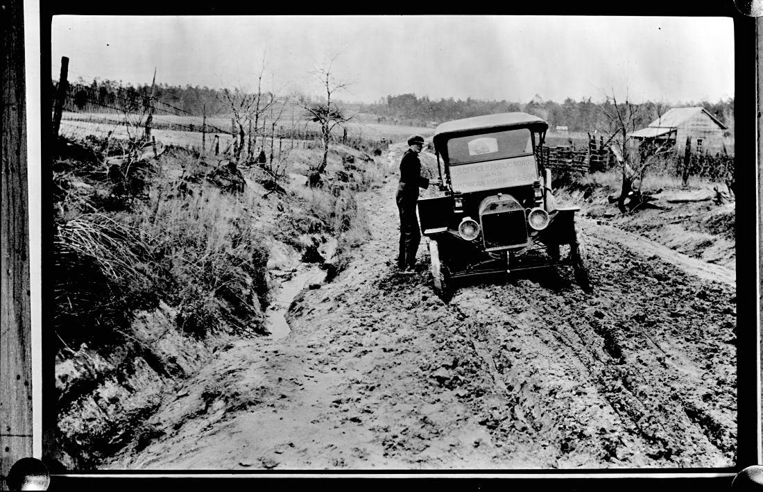 Historic photo of automobile stuck in mud