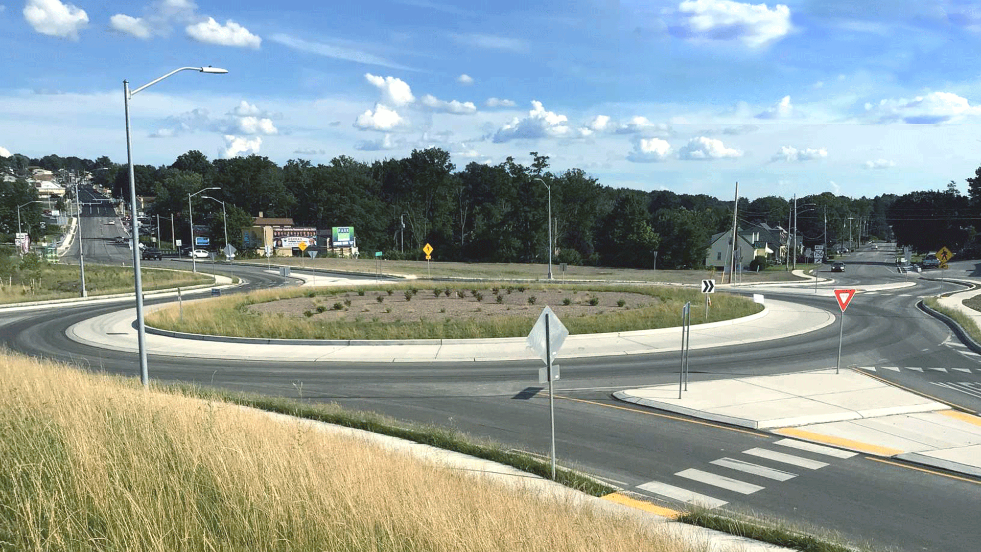 Cars driving on Scalp Avenue roundabout in the rain