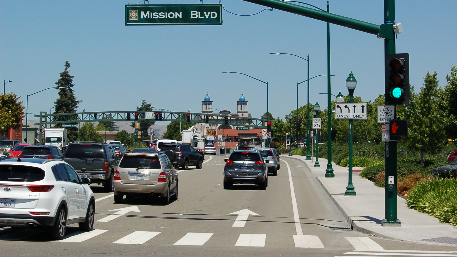 Intersection with cars and crosswalk.