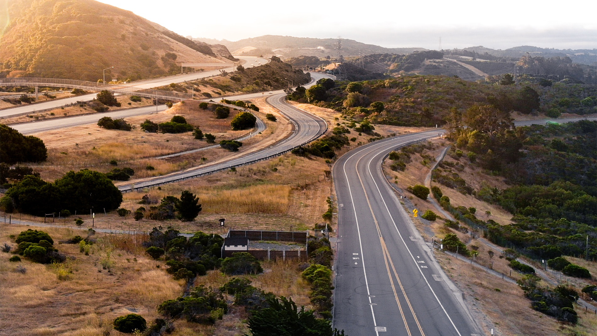 Image of California highway over rolling hills.