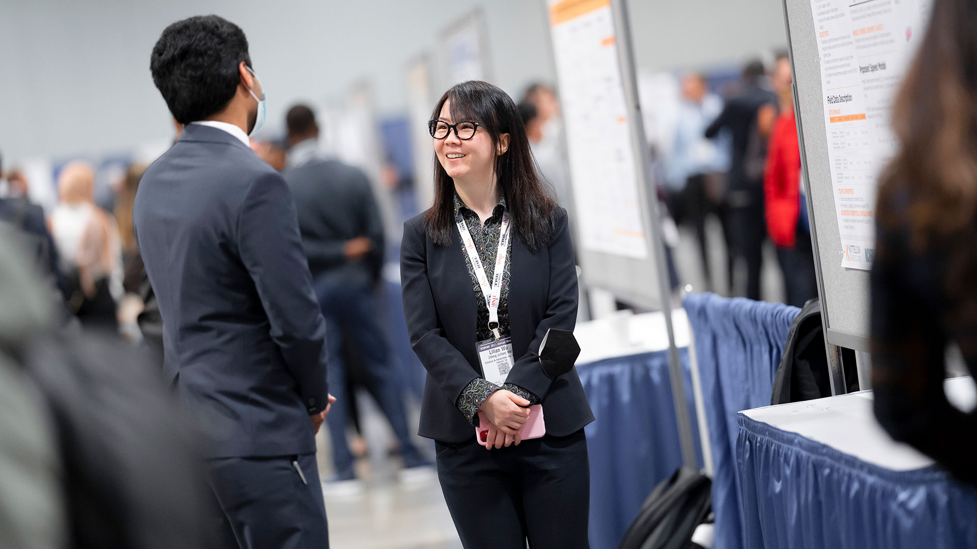 Two people interacting in front of a poster session at the TRB Annual Meeting