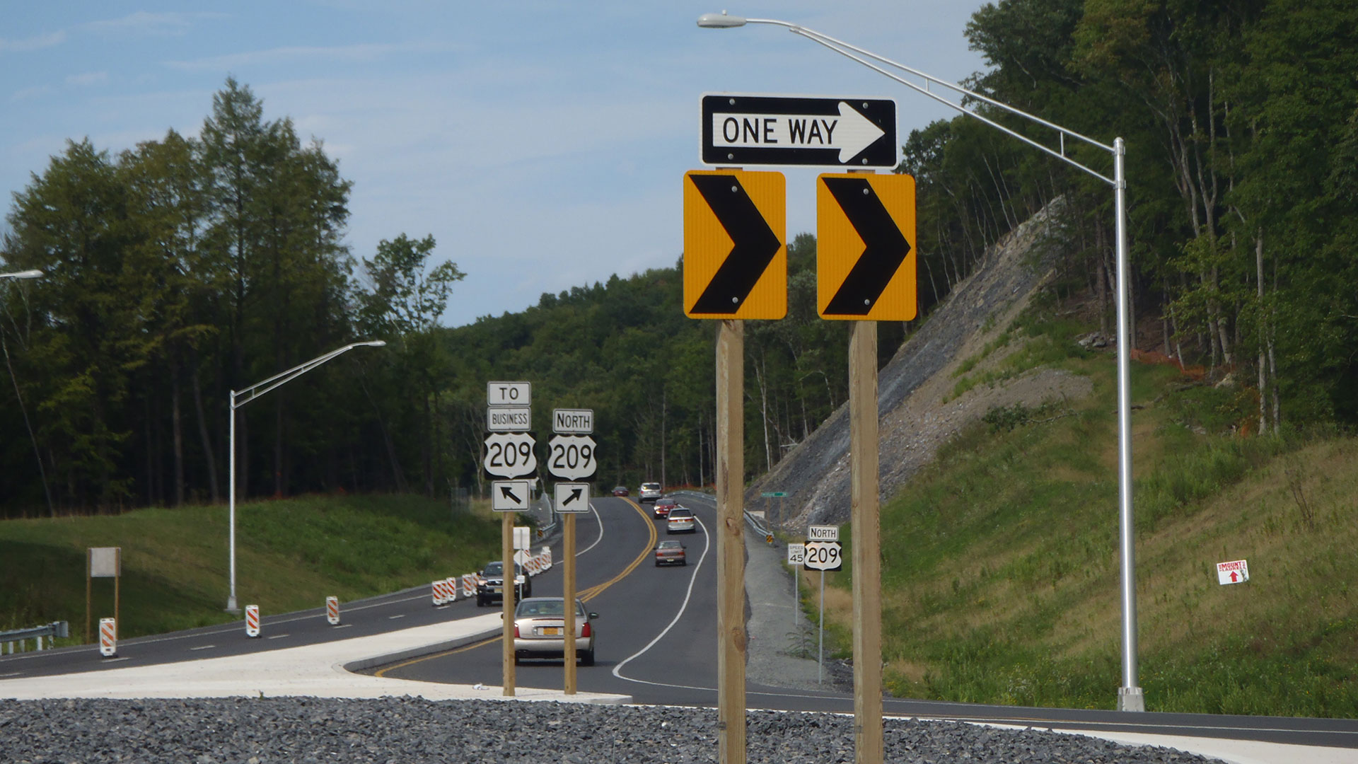 Photo of a one-way sign in front a roundabout