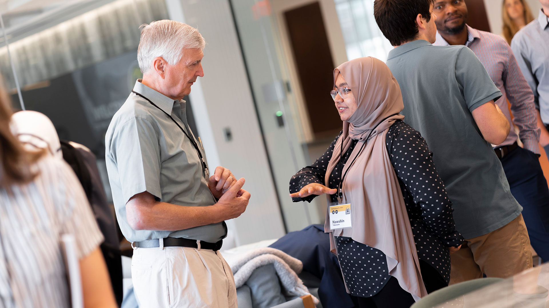 Two people having a conversation at the 2024 SCOUT Summit