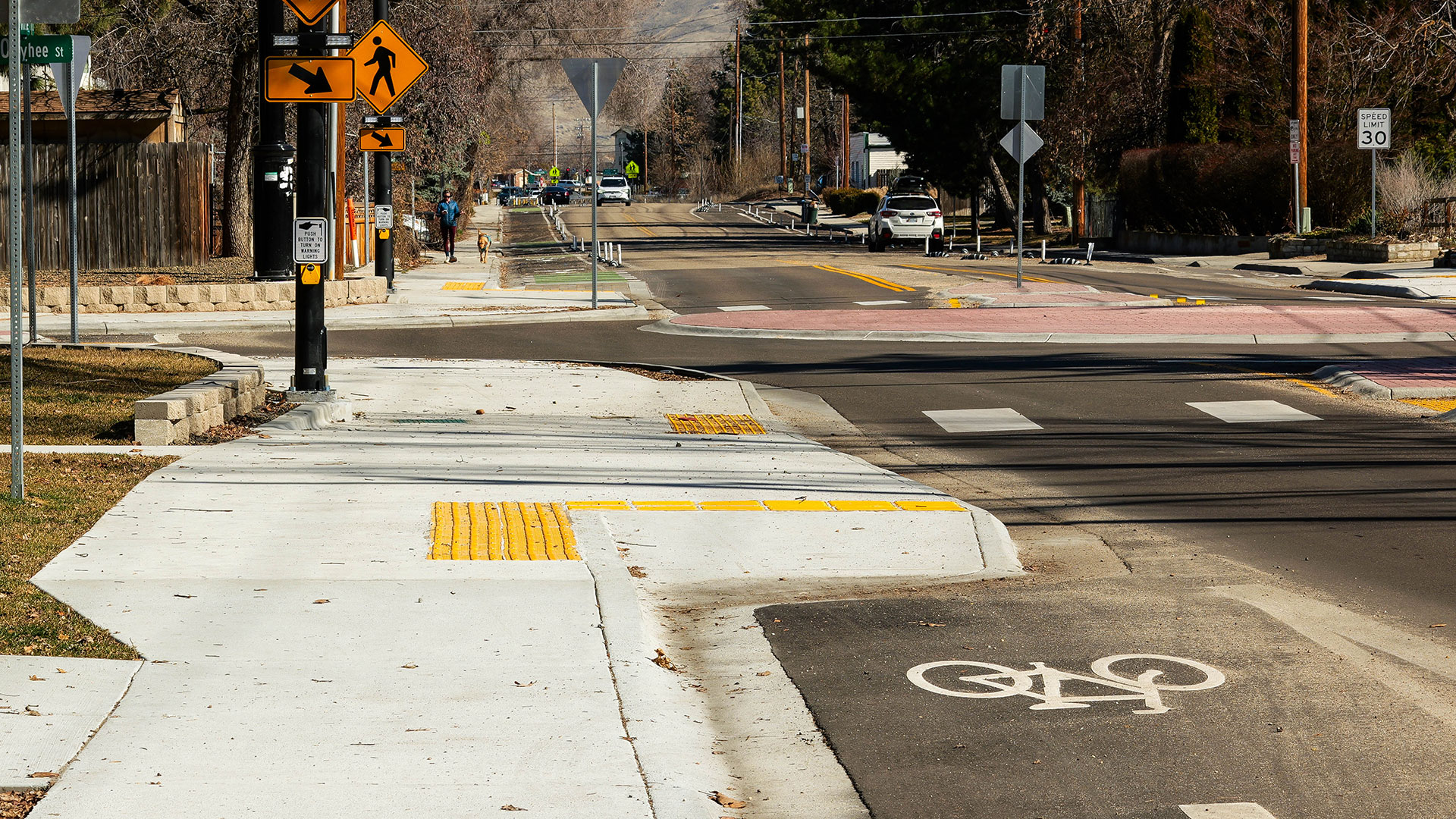 Close-up view of bike lane and sidewalk in front of a single-lane roundabout