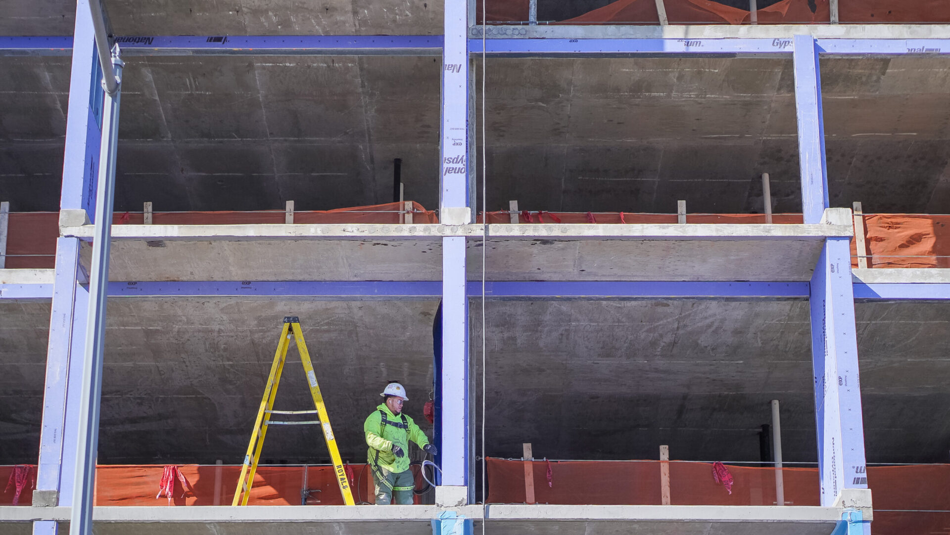 construction worker working on the second floor of concrete building