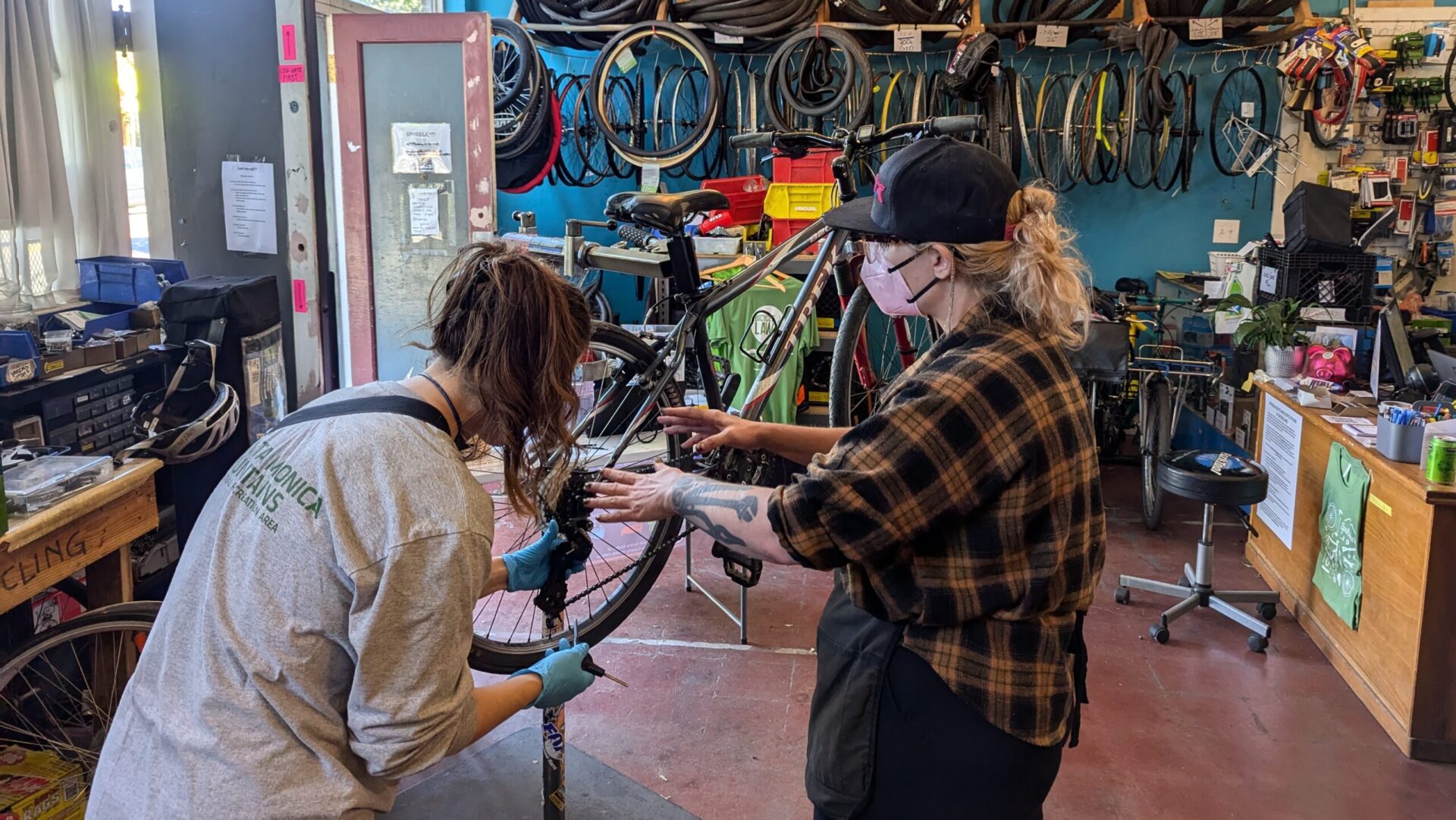 Two women working on bike repairs