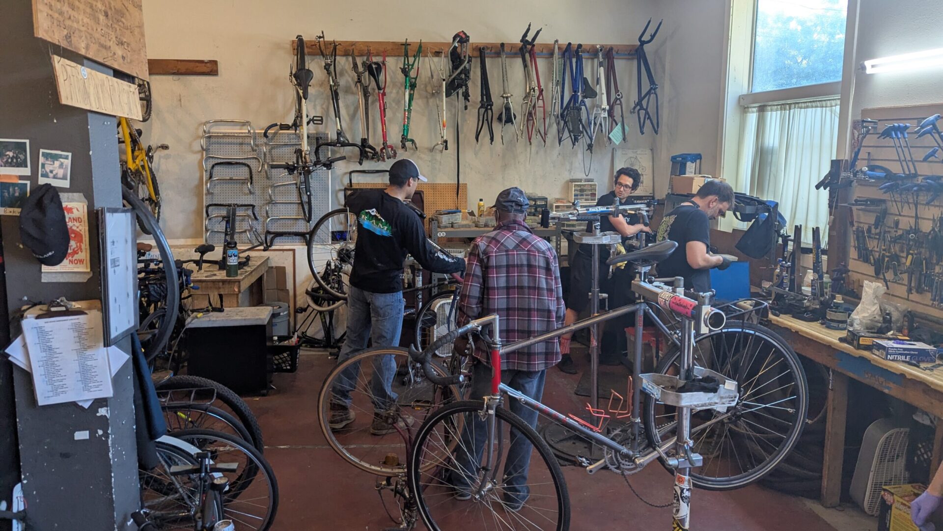 Group of people working on bike in bike co-op