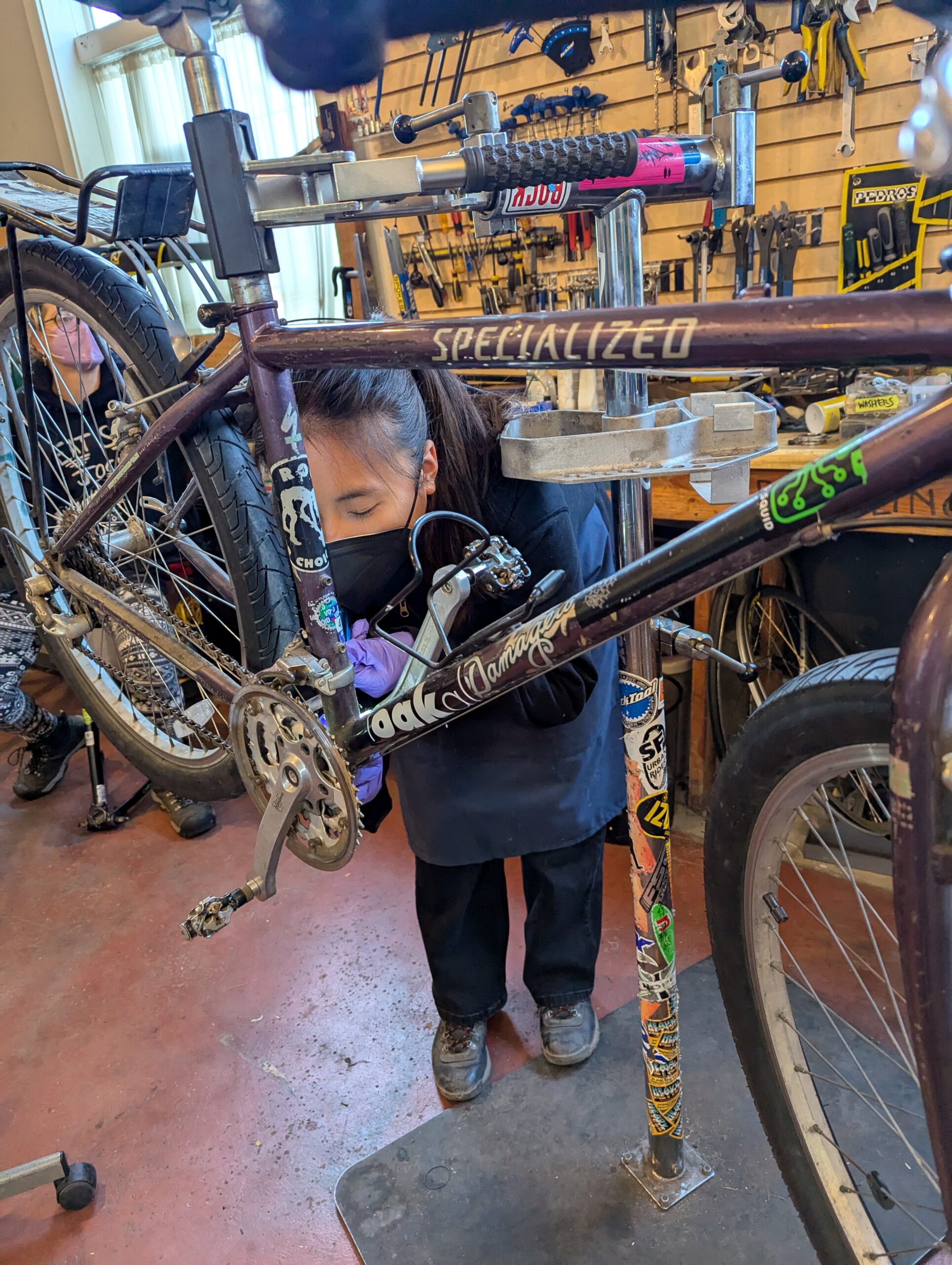 Woman repairing bike in bike shop