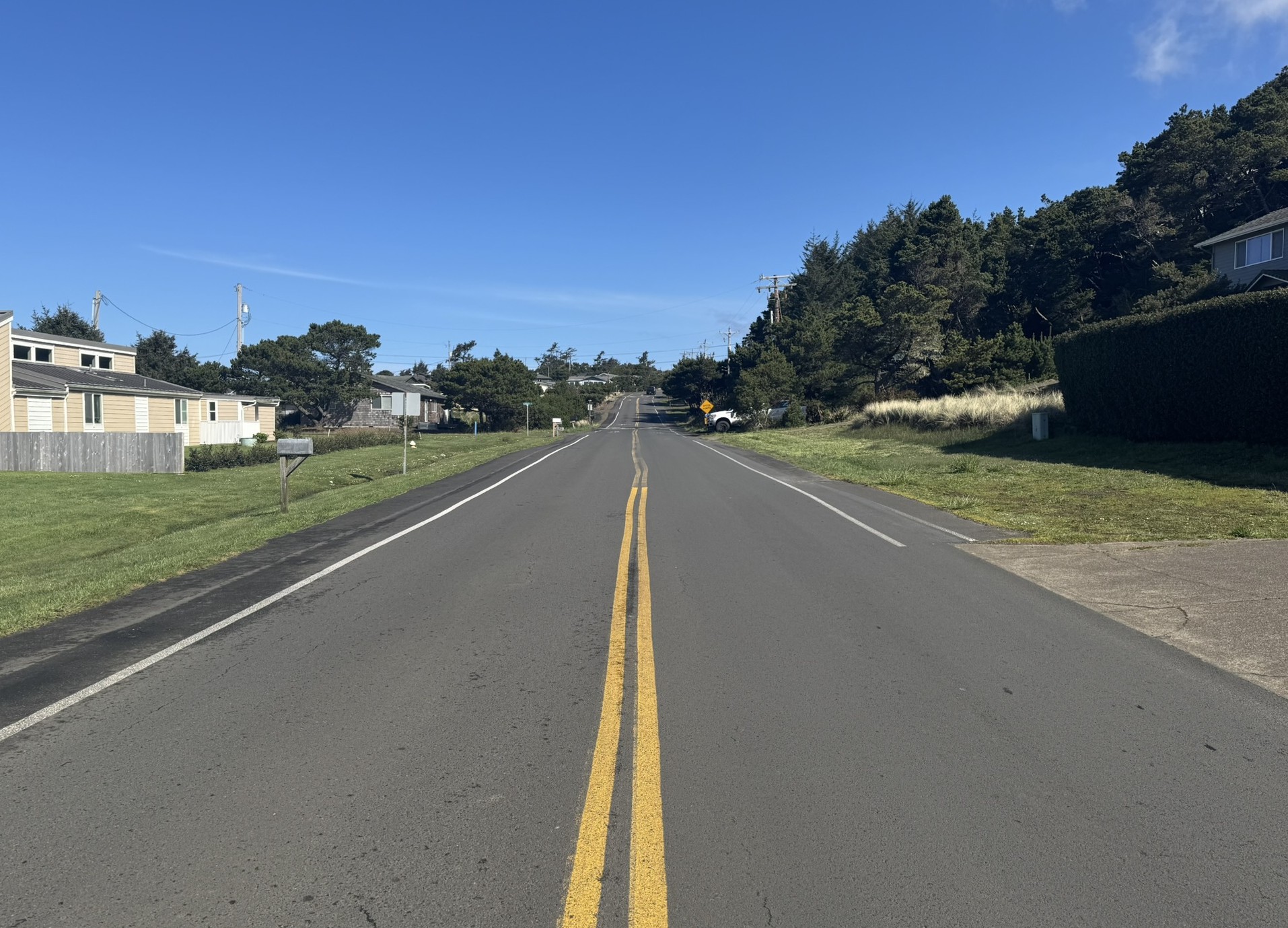 A newly striped roadway narrows the travel lanes for drivers and creates more room for people walking along the road's shoulder.
