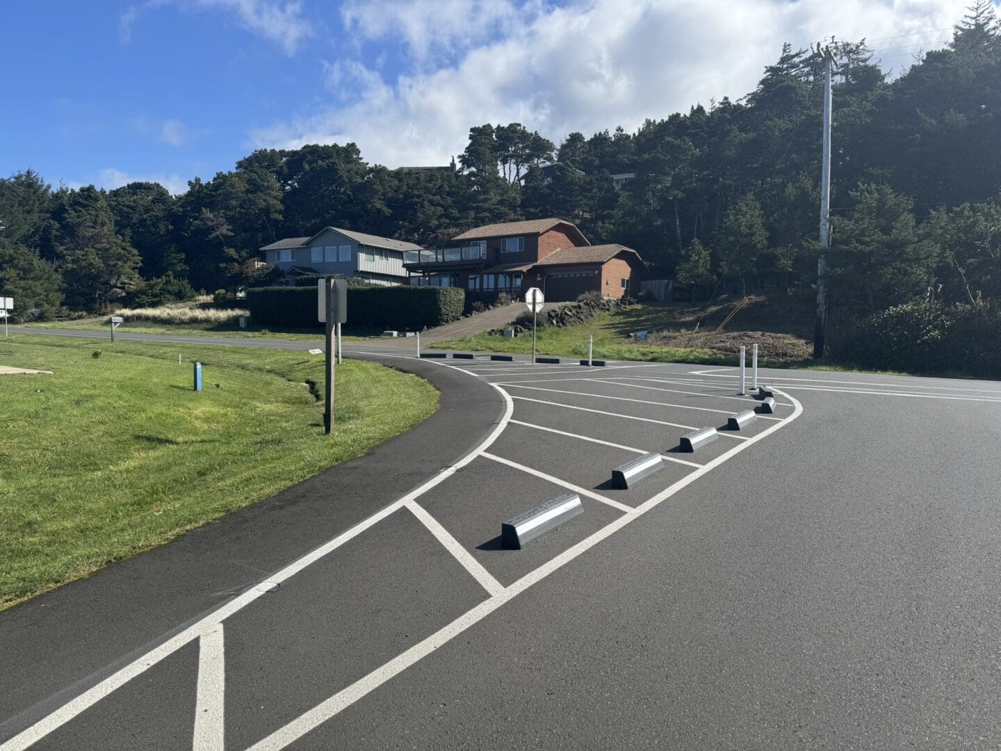 White paint and rubber curbs has transformed the intersection to have a gentler turning radius and created more space along the edge for people walking.
