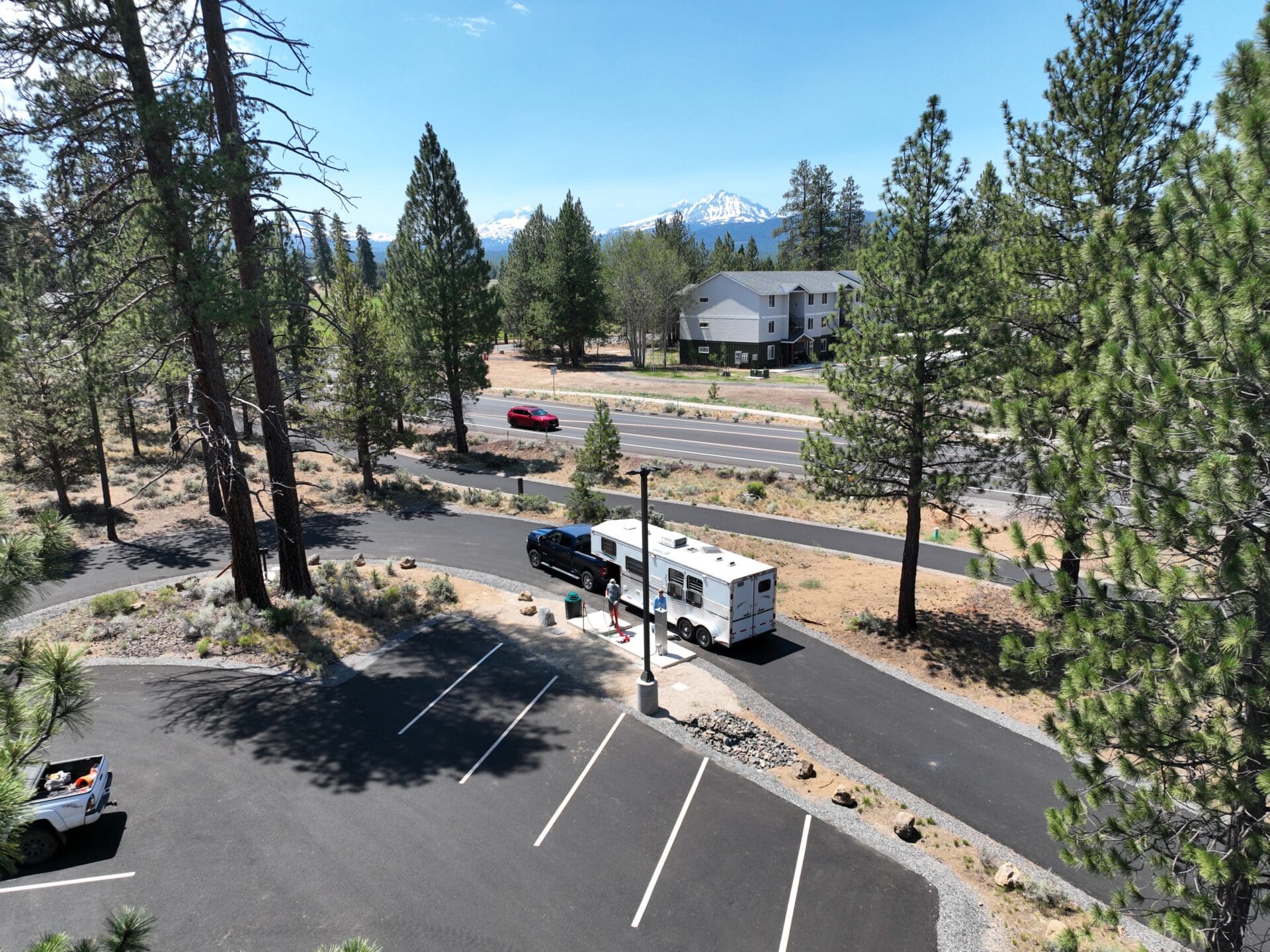 A truck and horse trailer navigates the new mobility hub roadway. A car is parked in one of the parking areas.