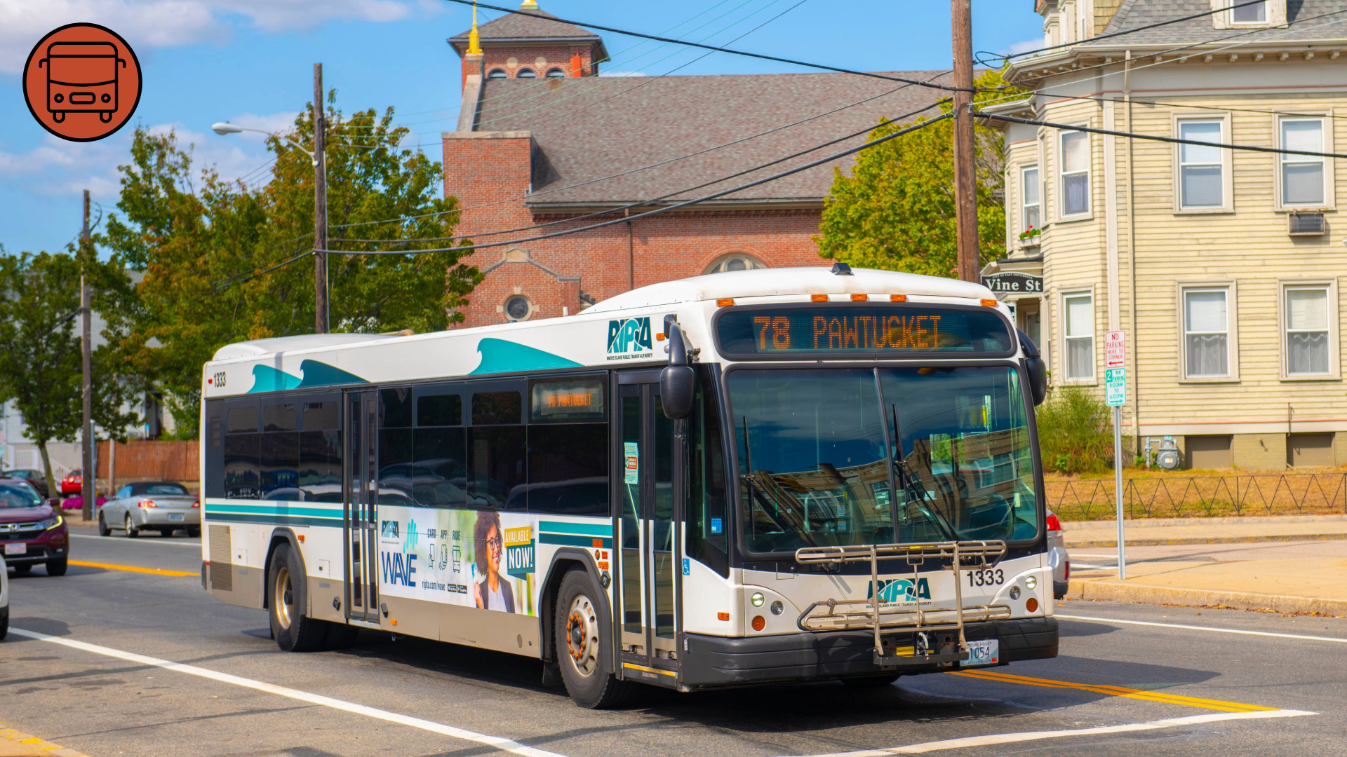 A photograph of a transit bus at an intersection.