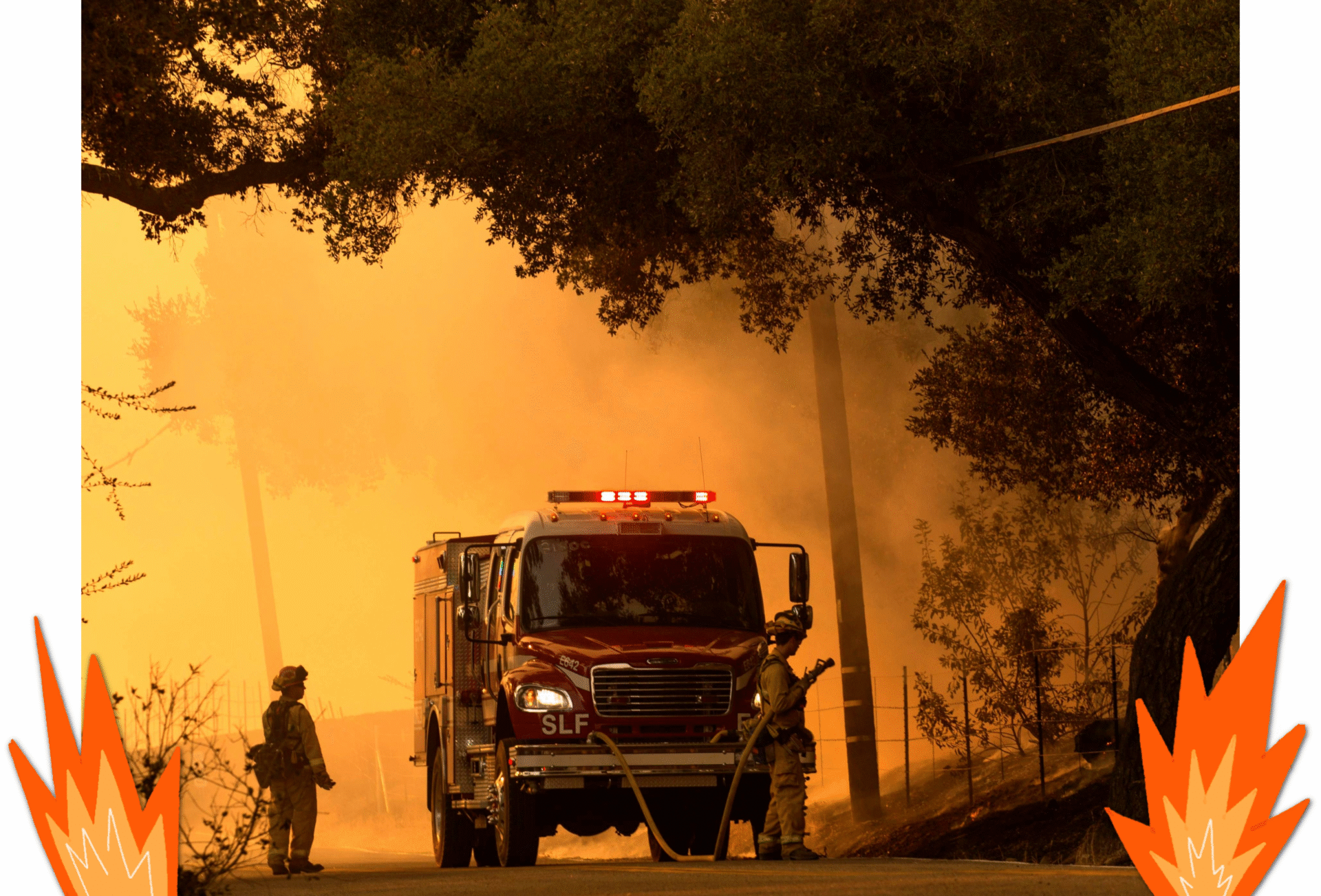 Two firefighters in protective gear stand next to a vehicle while fighting a brush fire.